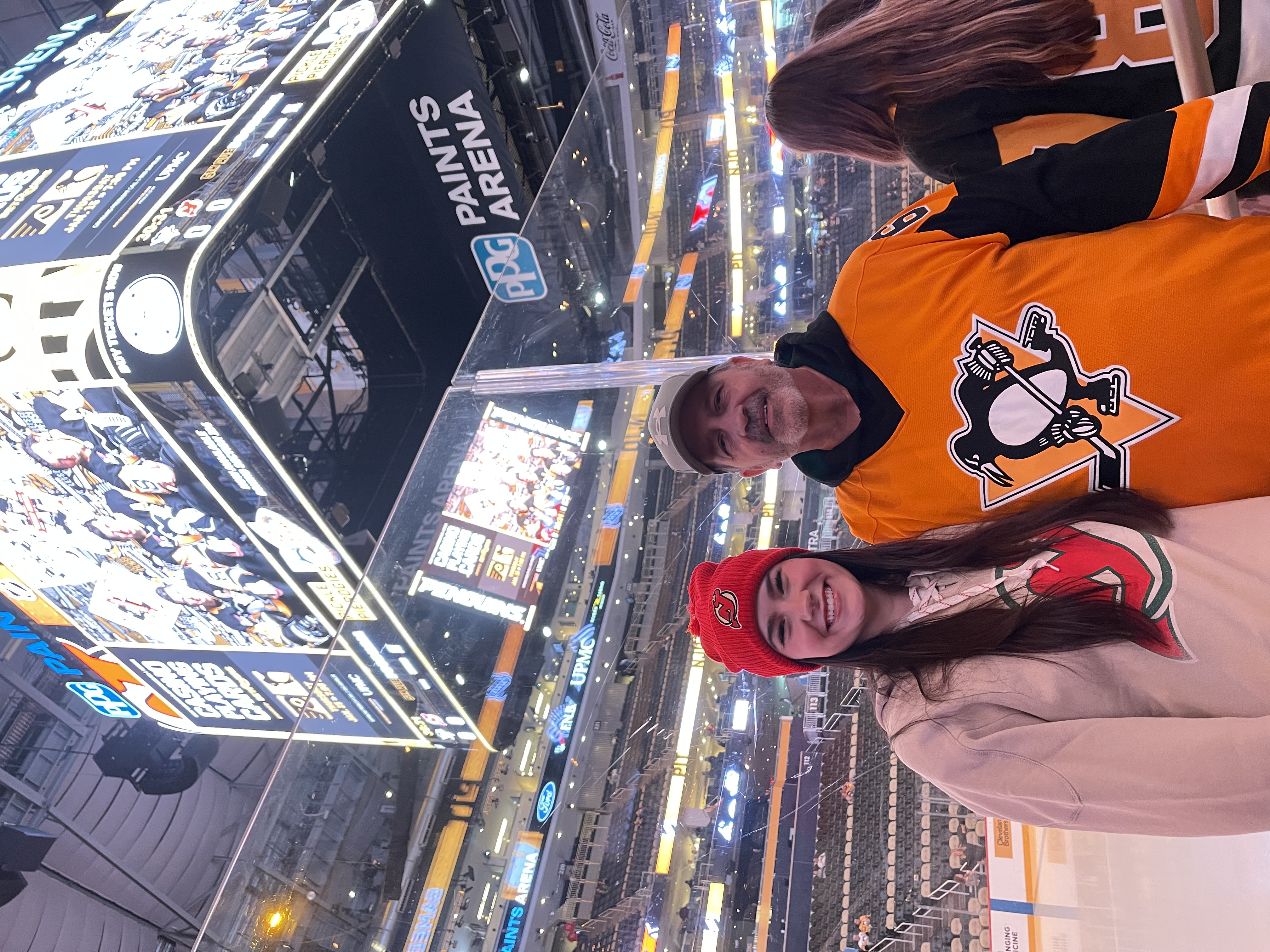 Abrielle and her dad at a Penguins game